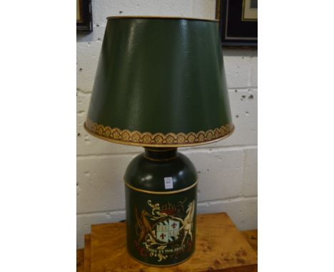 A large green Toleware style tea canister table lamp with armorial decoration.