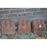 Twelve terracotta edging tiles.