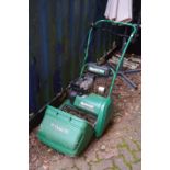A Qualcast petrol cylinder lawn mower.