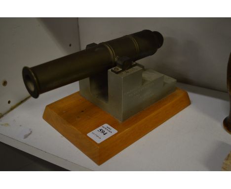 A small bronze model of a cannon.