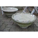 A pair of reconstituted stone circular planters.