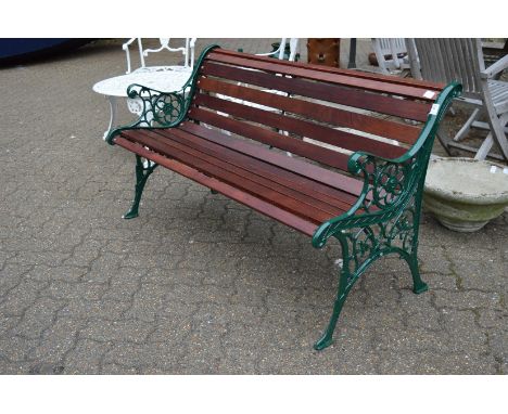 A new garden bench with green painted cast metal ends and hardwood slats.