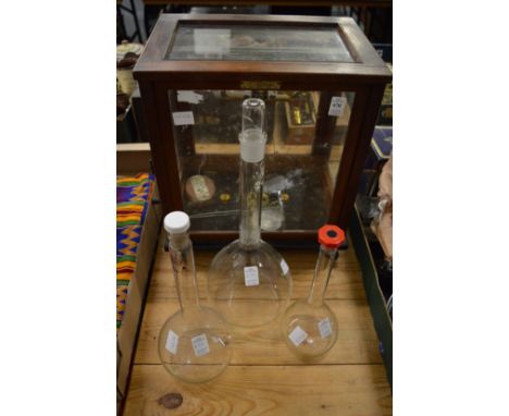 Scientific scales, in a mahogany case together with three scientific glass bottles.