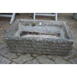 A pair of reconstituted stone rectangular plant troughs.