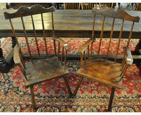 Two similar late 19th/early 20th Century Welsh primitive stick backed fireside armchairs, both with arched crestings, shaped 