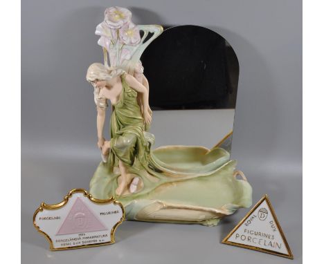 Royal Dux Art Nouveau porcelain dressing table mirror modelled as a girl taking off her shoes with a shallow organic design n