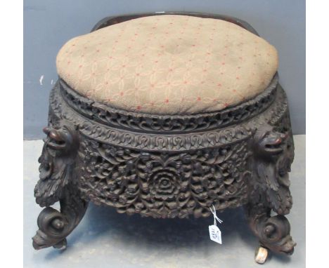 19th Century Indo-Burmese carved padouk wood stool of circular form with stuff over upholstered seat with carved floral and f