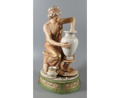 Royal Dux Art Nouveau porcelain figure of a lady potter with her vase and wheel sitting on a stool, shape no. 349 with pink t