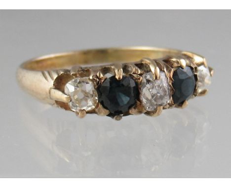 Sapphire and diamond five stone ring set in yellow metal.  Ring size L & 1/2.  Approx weight 2.1 grams.(B.P. 21% + VAT) 