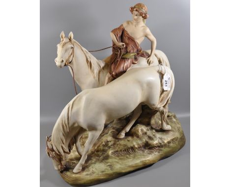 A Royal Dux Art Nouveau porcelain figure group of two horses, one with a young lady sitting astride, on a naturalistic base. 
