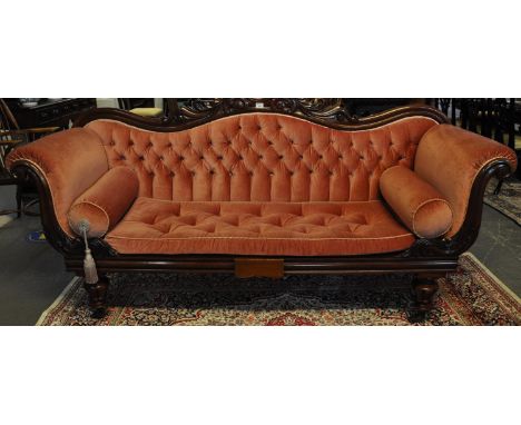 Victorian mahogany button back upholstered double ended sofa, the carved foliate and shaped back with scroll arms, standing o