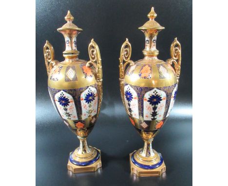 Pair of Royal Crown Derby bone china Imari two handled lidded vases. 32cm high approx. (B.P. 21% + VAT) Finial and base very 