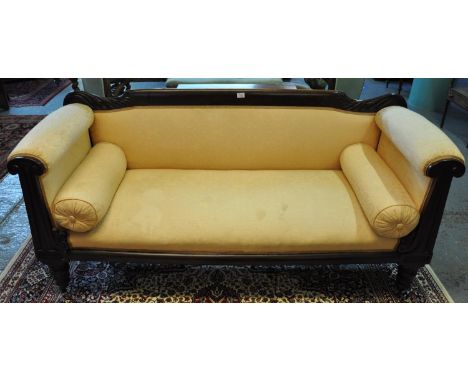 Victorian mahogany double ended upholstered sofa, the shape and carved back with padded and carved arms, standing on tapering