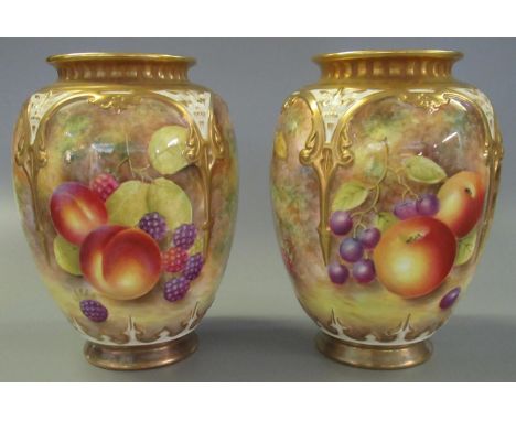 Pair of 1970's Royal Worcester hand painted vases of baluster from decorated with fruits, foliage and berries. Both signed Le