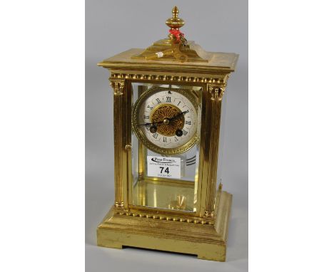 Early 20th Century brass four glass mantel clock having ceramic Roman chapter ring, two train movement striking on one gong w