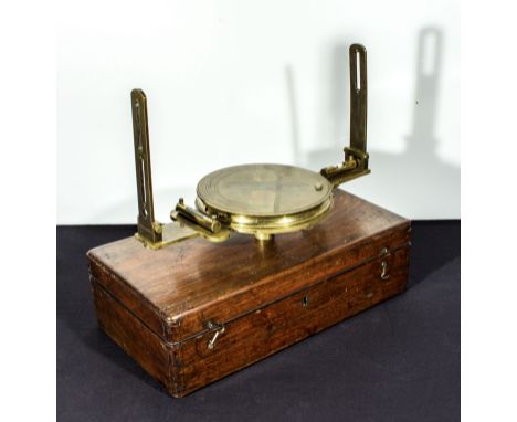 A brass compass in wooden case