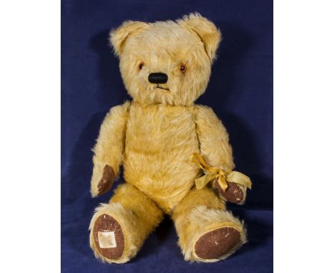 A 1940/50's Chad Valley teddy bear with Royal Appointment label, rexine paws and pads, safe glass eyes, fading growler in sof