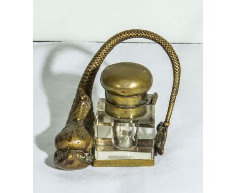 A brass dolphin inkwell