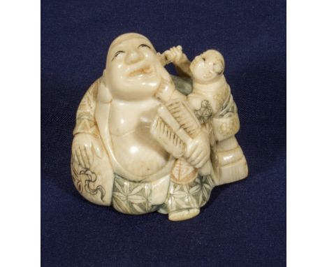 An ivory netsuke, Buddha with boy