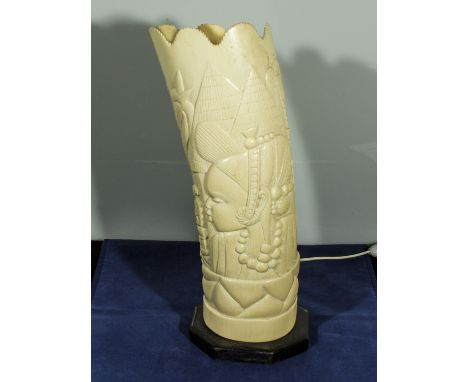 A carved ivory tusk modelled as a table lamp