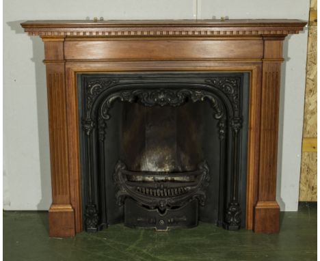 A reproduction pine fire surround with cast insert