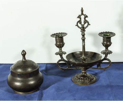 A metal candlestick and a lidded pot