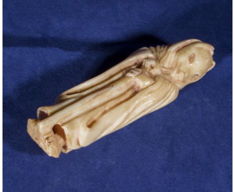 An ivory netsuke modelled as a wolf