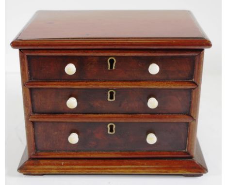 Mahogany tea caddy in form of a chest of drawers ivory knobs and twin lidded interior. Length 19cms approx Height 15.5cms app