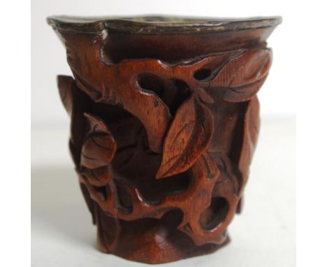 Qing dynasty carved bamboo libation cup in the form of a hollow trunk within fruiting finger citron boughs in pierced relief 