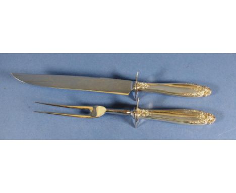Vintage sterling silver handled carving set handles marked sterling, with embossed decoration. Two pieces, including carving 