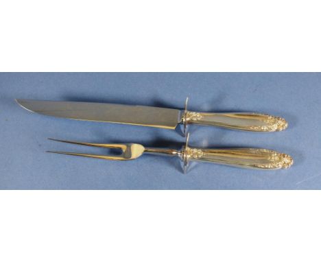 Vintage sterling silver handled carving set handles marked sterling, with embossed decoration. Two pieces, including carving 