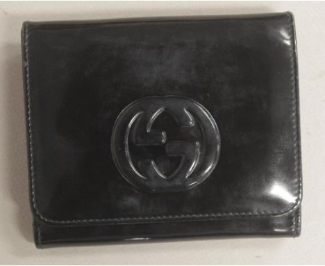 Vintage Gucci black patent leather wallet with raised Gucci monogram to front of button coin compartment and back button open