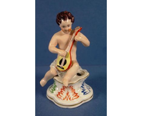 Antique Staffordshire figural inkwell in form of figure playing a mandolin. Height 13cms approx.