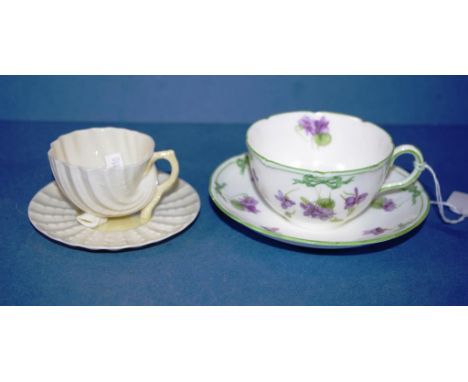 Two various teacups and saucers including early Royal Doulton, violet decorated, marked HB6720; and Belleek cup and saucer, s