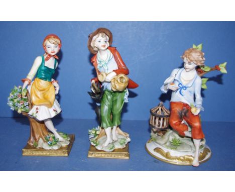 Three Naples ceramic figurines comprising boy with bird, boy with umbrella & girl with basket, 21cm high (tallest) approx.