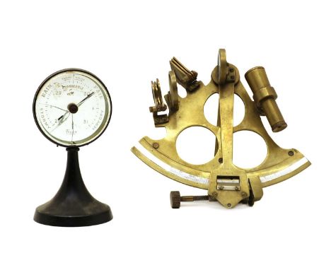 A brass sextant, stamped 'Stanley, London', 18cm high and a desk top barometer by 'Tyco's, London', on a black metal base, 16