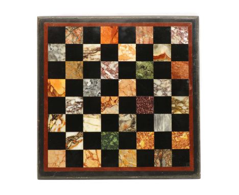 A marble, hardstone and slate chess board, 19th century, inlaid with a variety of specimens to include porphyry, serpentine a