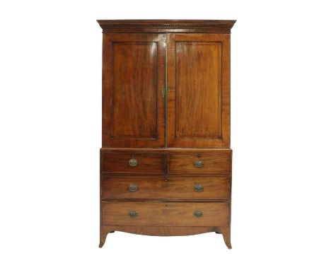 A George III mahogany linen press, the dentil moulded cornice above a pair of ebony strung doors, enclosing a hanging compart