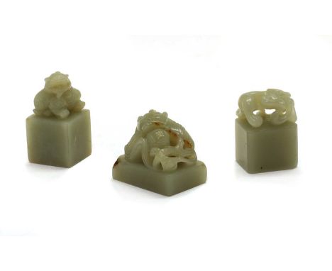 A collection of three Chinese jade seals, comprising: one with the finial carved of a chilong crouching with its head turned 