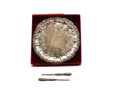 A continental silver salver, the piecrust border with embossed leaf and shell decoration, 25.5cm diameter, together with two 