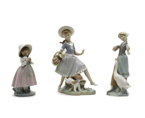 Three china figures, comprising: two by Lladro of a girl with puppy and basket of flowers, a girl with goose, one by Nao of a