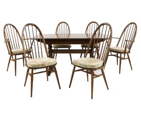 An Ercol dining suite, comprising a set of six beech and elm Quaker chairs, to include two elbow chairs, 64cm wide, 100cm hig