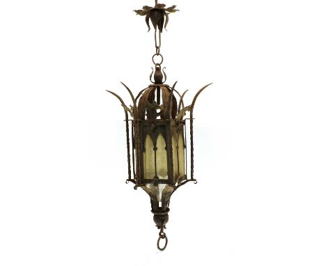 A hexagonal iron hanging porch lantern, first half of 20th century, with glazed panels, chain and top rose. 77cm high overall