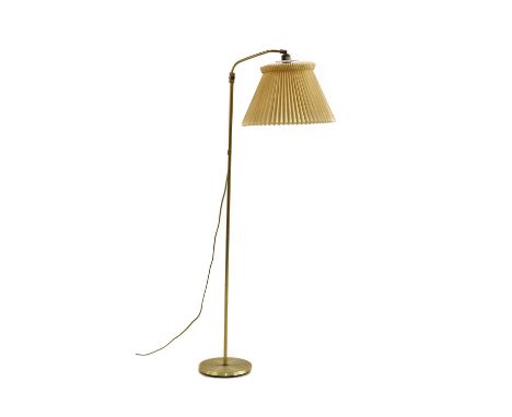 A brass standard lamp, model 2012, by Schmidt Lampedesign, Germany, circa 1970s, with an adjustable lamp arm, with a folded p