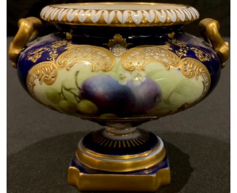 An early 20th century Royal Worcester gilded two handled pedestal urn, painted panel of fruit on blue ground, signed R. Sebri