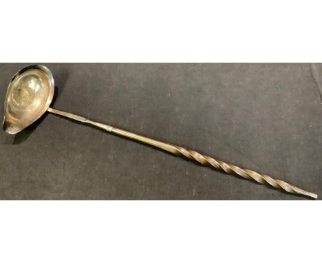 An 18th century silver coloured toddy ladle, whale bone handle, the bowl later inset with a 1725 shilling 