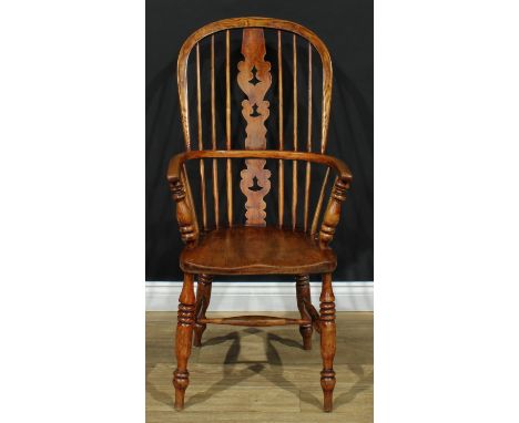 A 19th century Yorkshire Windsor elbow chair, hoop back, shaped and pierced 'Christmas Tree' splat, turned arm posts, saddle 