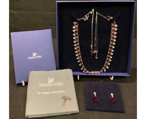 A Swarovski crystal/ruby necklace; matching earrings and pendant on chain; Swarovski jewellery cleaning kit, boxed 