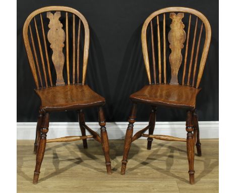 A pair of 19th century Windsor-form side chairs, each with a hoop back, shaped splat, saddle seat, turned legs, H-stretcher, 