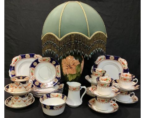 A Moorcroft hibiscus pattern baluster table lamp; an Edwardian Staffordshire Imari pattern part tea service, etc 